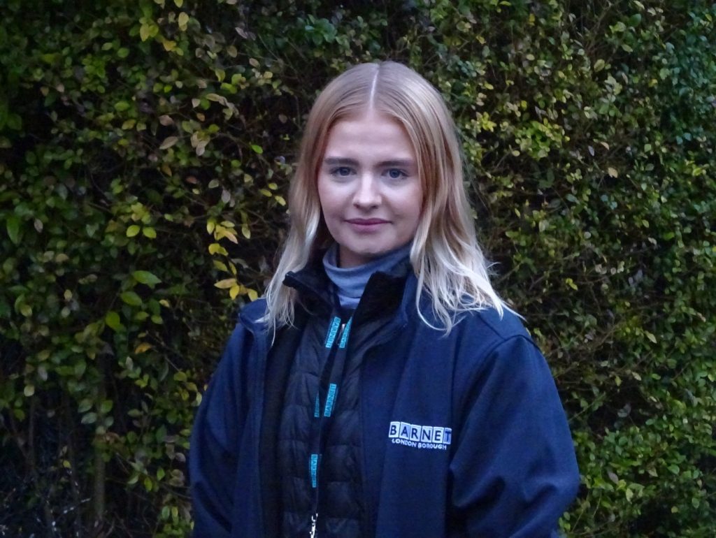 Harriet Duffield, 
Biodiversity and Conservation Officew with a hedgerow in the background -  Green Spaces